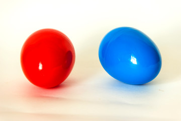 blue and red plastic egg on a white background
