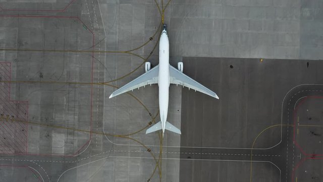 airfield. Aircraft towing. Preparing the plane for flight. Airport technical services. Airplane Service. Airbus A330 top view. Aerial view. airplane Unnamed, Pure white fezulage of an airplane.