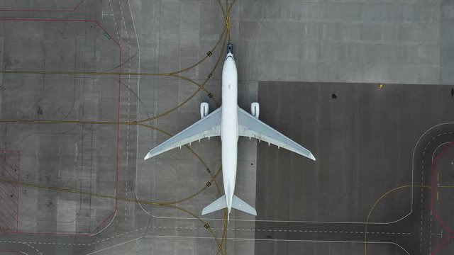 airfield. Aircraft towing. Preparing the plane for flight. Airport technical services. Airplane Service. Airbus A330 top view. Aerial view. airplane Unnamed, Pure white fezulage of an airplane.