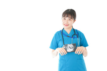 妊婦のエコー画像と笑顔の若いナース