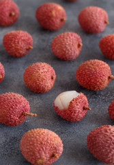 Fresh litchi fruits on a grey table