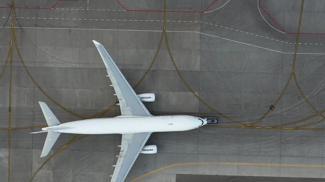 airfield. Aircraft towing. Preparing the plane for flight. Airport technical services. Airplane Service. Airbus A330 top view. Aerial view. airplane Unnamed, Pure white fezulage of an airplane.