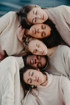 The portrait of multiracial group from five women.