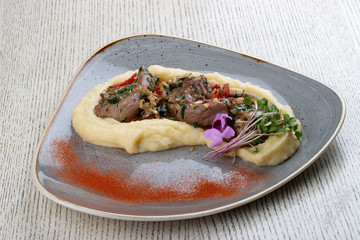 Lamb tongues with mashed potatoes, stewed in a sauce with thyme and herbs