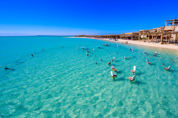 Fototapeta na wymiar Orange Bay Beach with crystal clear azure water and white beach - paradise coastline of Giftun island, Mahmya, Hurghada, Red Sea, Egypt.
