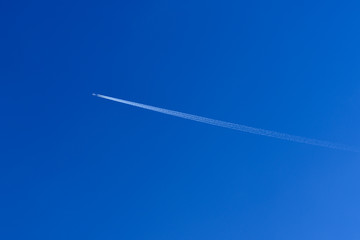 Airplane Vapour Trail Across a Blue Sky