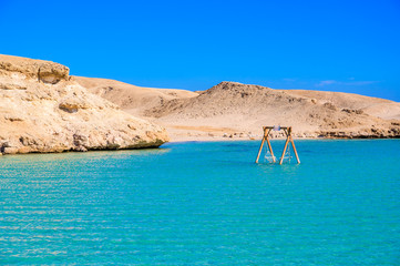 Orange Bay Beach with crystal clear azure water and white beach -  hammock in the water for...