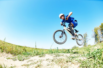 cyclist riding jumping with bicycle cross-country