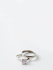 Wedding and engagement rings with diamond. Symbol of love and marriage on white background.