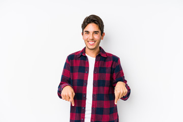 Young caucasian man posing in a pink background isolated points down with fingers, positive feeling.
