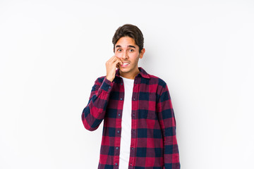 Young caucasian man posing in a pink background isolated biting fingernails, nervous and very anxious.