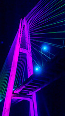 Fototapeta na wymiar Mahkota bridge in Samarinda, Indonesia at night with beautiful lights. It cross Mahakam river.