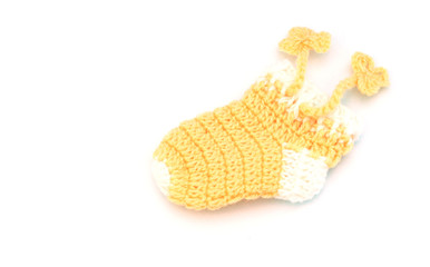 Handmade sweet baby booties isolated on white background