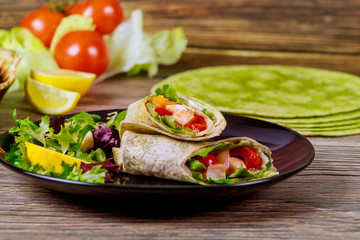 Wrap with meat and vegetable made from spinach tortillas.