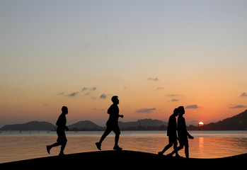 Silhouette running exercise n the evening atmosphere Sunset.