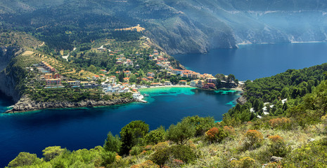 Obraz premium Wonderful summer seascape of Ionian Sea. Wonderful place for holiday. Amazing Greece. Picturesque colorful village Assos in Kefalonia. Turquoise colored bay in Mediterranean sea. Aerial view. panorama