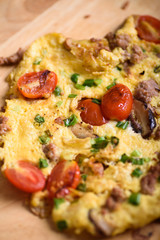 Thai style minced pork omelette on a brown wooden background