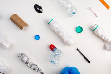 plastic trash on a white background. environmental pollution. Flay lay. Copy space top view