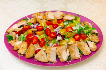 A dish of Caesar salad is on the table. Chicken salad made at home. Mediterranean cuisine.