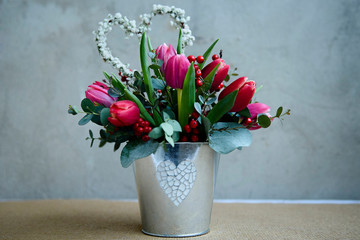 bouquet of flowers tulips and decor in the form of a heart