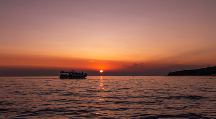 Fototapeta na wymiar Boat. SunSet. Sky. Orange. Sea. Istria