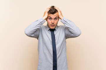 Young blonde businessman over isolated background with surprise facial expression
