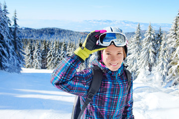 Young woman skier portrait in winter mountain ski resort