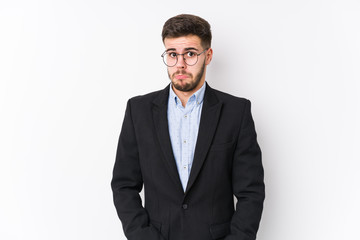Young caucasian business man posing in a white background isolated Young caucasian business man shrugs shoulders and open eyes confused.