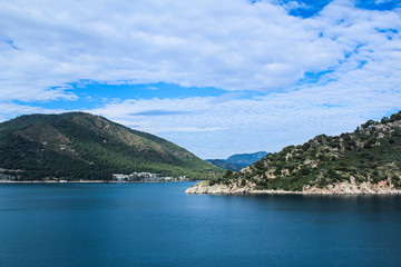 Travel concept: blue sea and mountains; view over the bay, selective focus