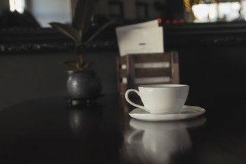 Coffee cup in coffee shop - vintage style effect picture