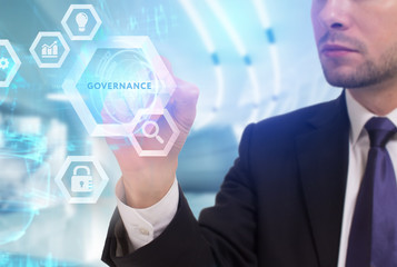 Business, Technology, Internet and network concept. Young businessman working on a virtual screen of the future and sees the inscription: Governance