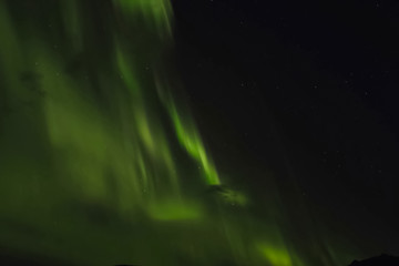 Aurora borealis in night northern sky. Ionization of air particl