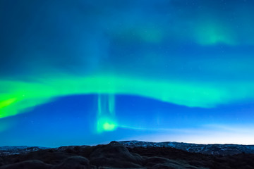 Aurora borealis in night northern sky. Ionization of air particl