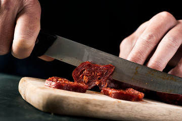 cutting chorizo, spanish cured pork sausage.