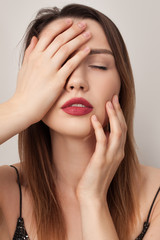 Fototapeta premium Portrait of a sensual woman. Face close up. Red lipstick
