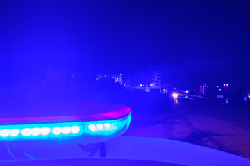 Fototapeta na wymiar police car flashing lights in the night selective focus