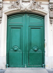 Old fashioned front door entrance, white facade and green door, Paris, France