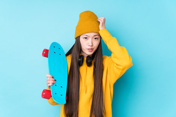 Young chinese skater woman isolated being shocked, she has remembered important meeting.