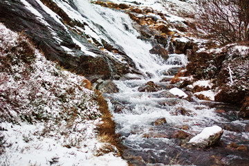 Fototapeta na wymiar Mountain waterfall shoot in winter, Lofoten islands.
