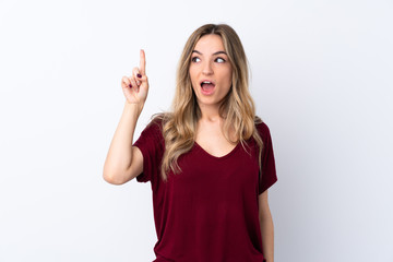 Young woman over isolated white background intending to realizes the solution while lifting a finger up