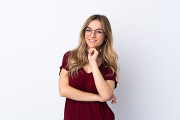 Young woman over isolated white background with glasses and smiling
