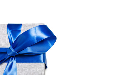 Blue bow on a gift of satin ribbon. Isolated on white. Place for text