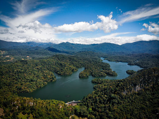 Aerial view of rain forest with blue sky background.