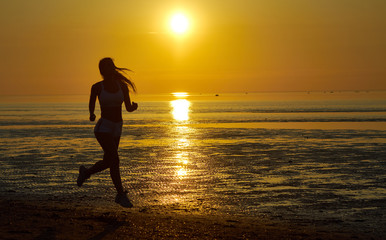 Plakat girl running by the sea on the beach