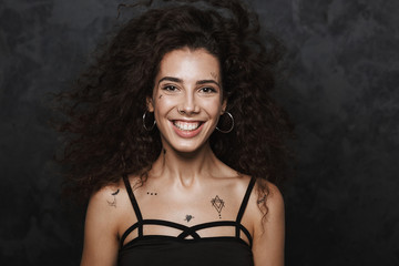 Image of nice cheerful woman smiling and looking at camera