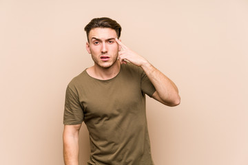 Young caucasian man posing isolated showing a disappointment gesture with forefinger.