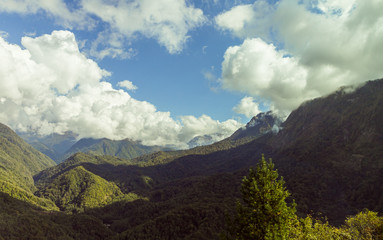 Fototapeta premium Mountain slopes covered with forests and low thunderclouds in Svaneti in the mountainous part of Georgia