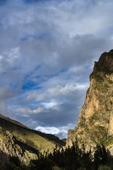 landscape with mountains and clouds and sun 