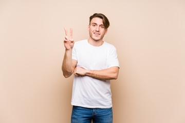 Young caucasian man posing isolated showing number two with fingers.