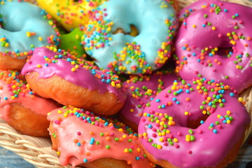assorted donuts with chocolate frosted, pink glazed and sprinkles donuts.